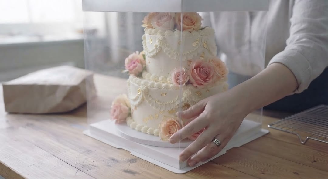Boxing the finished floral cake for delivery